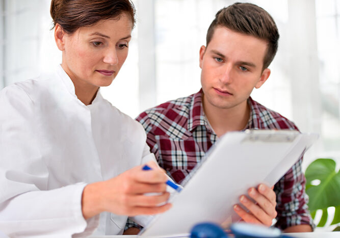 doctor talking to her male patient at office